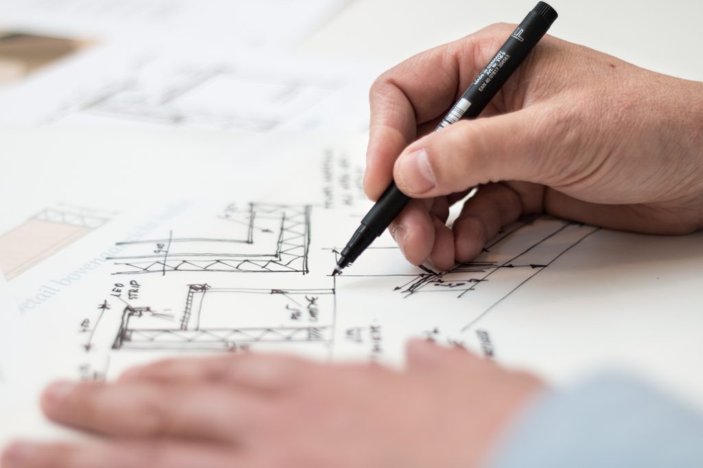 Person drawing architectural plans