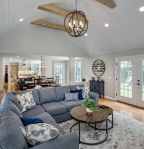 open concept living room dining room and kitchen addition in rhode island with vaulted ceilings