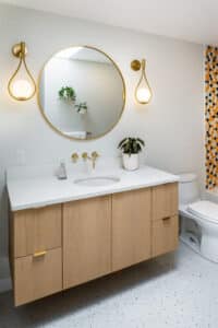 Floating vanity with accents of brass and stone