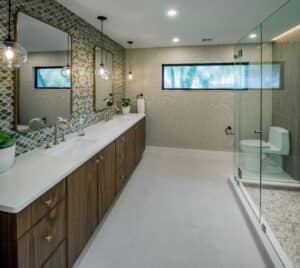 walnut tones mixed with brass and earthy greens in this hotel-like primary bathroom