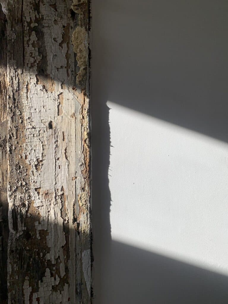 crumbling lead paint on a wooden post