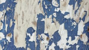 blue lead paint chipping off a wall